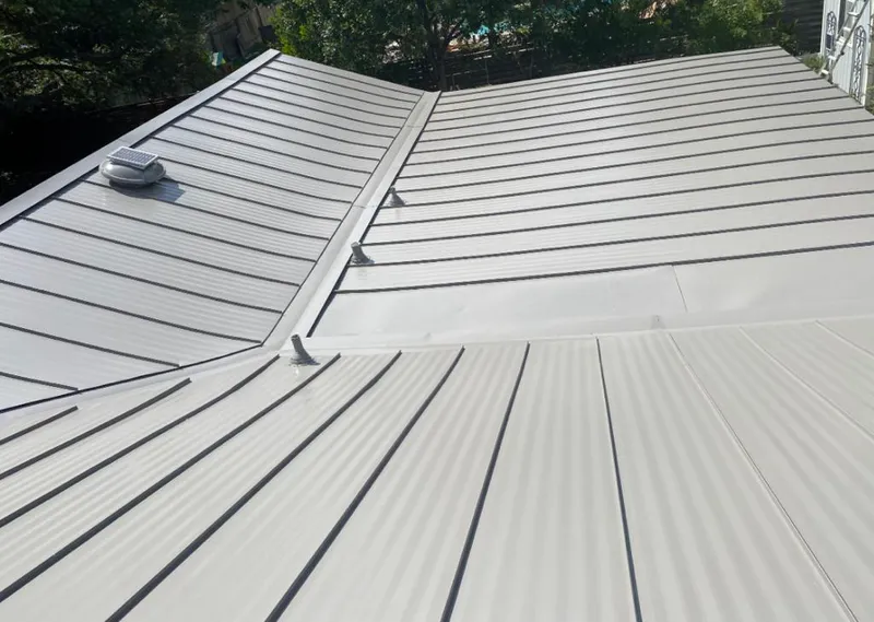 Solar attic fan installed on a metal roof for Roof Ventilation in Kaukauna